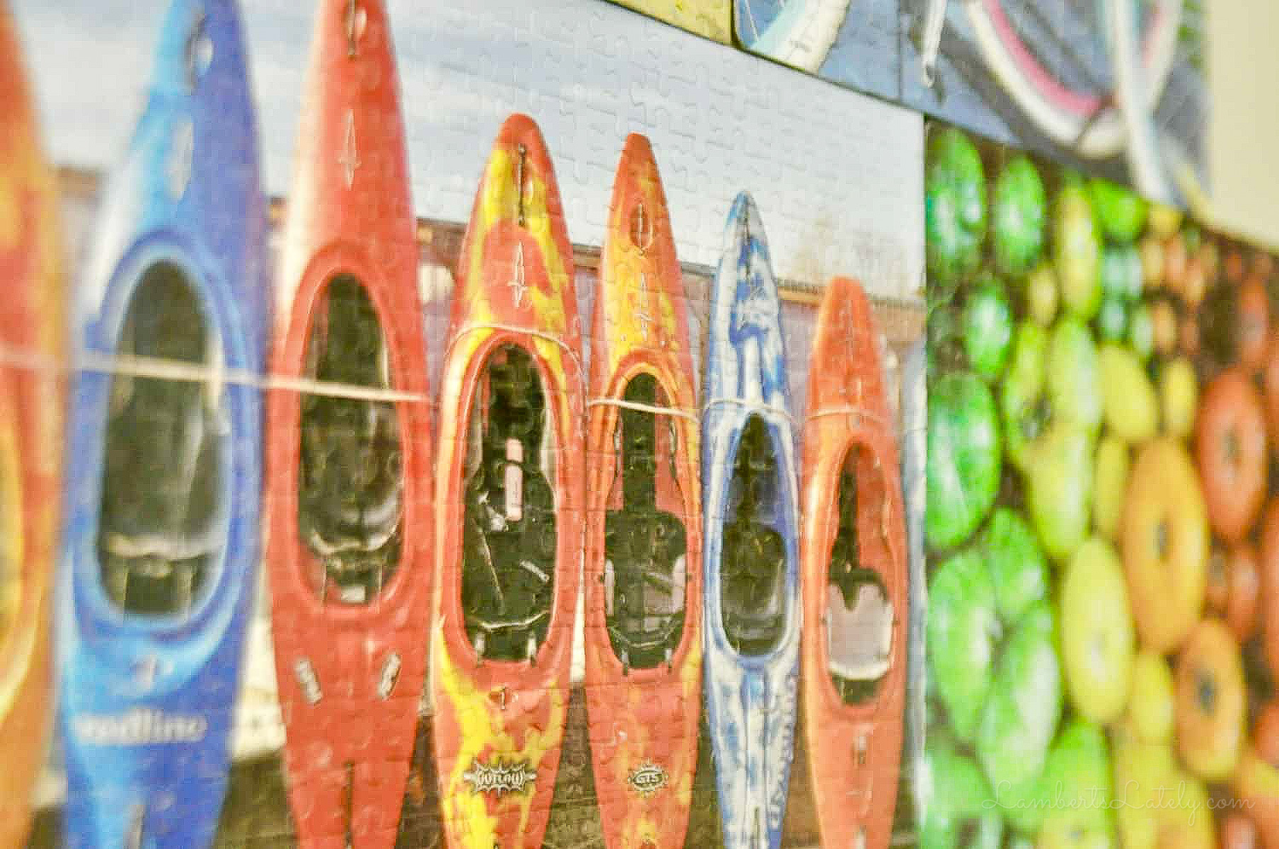 close up of glued puzzles displayed on a wall.