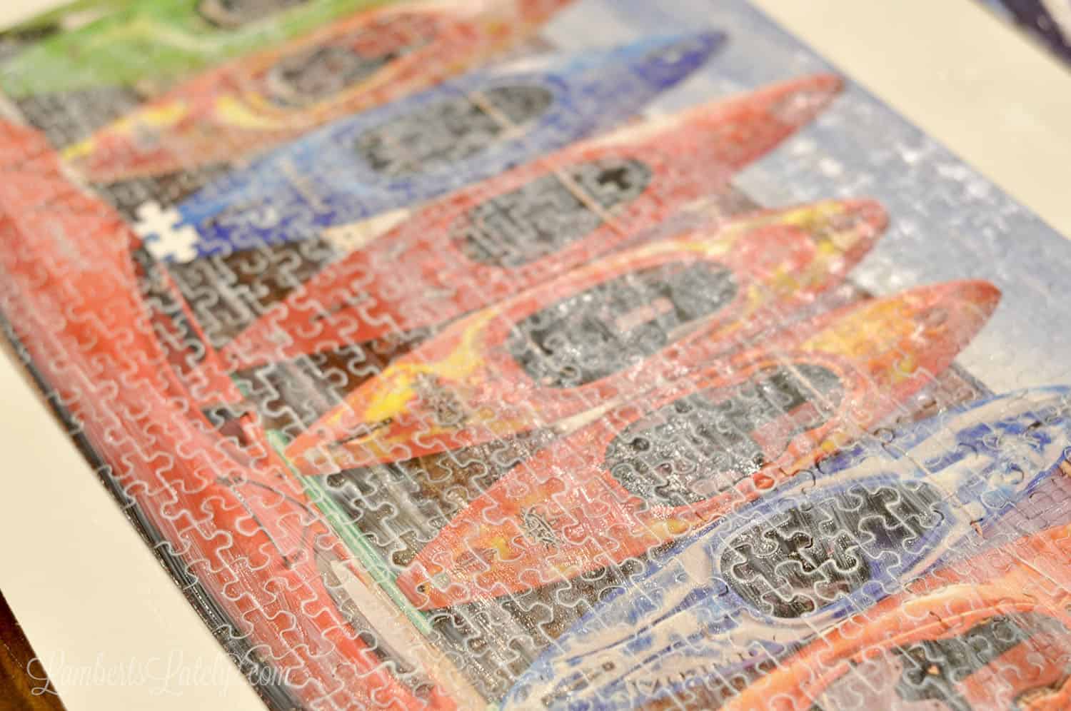 mod podge brushed onto the front of a puzzle, slightly cloudy before drying.