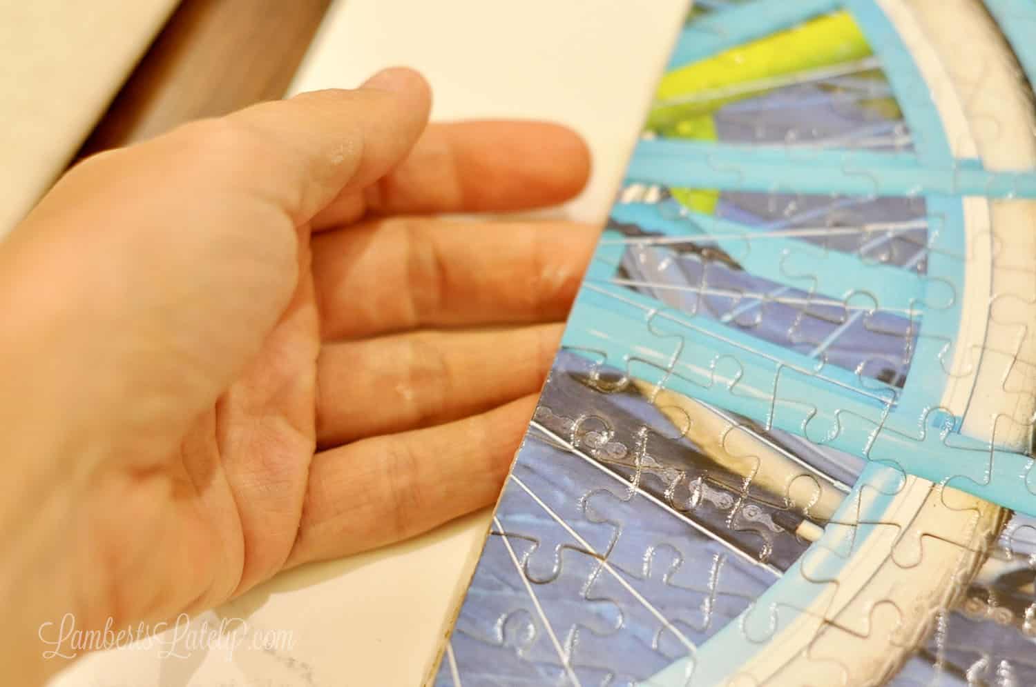 removing a preserved puzzle from poster board.
