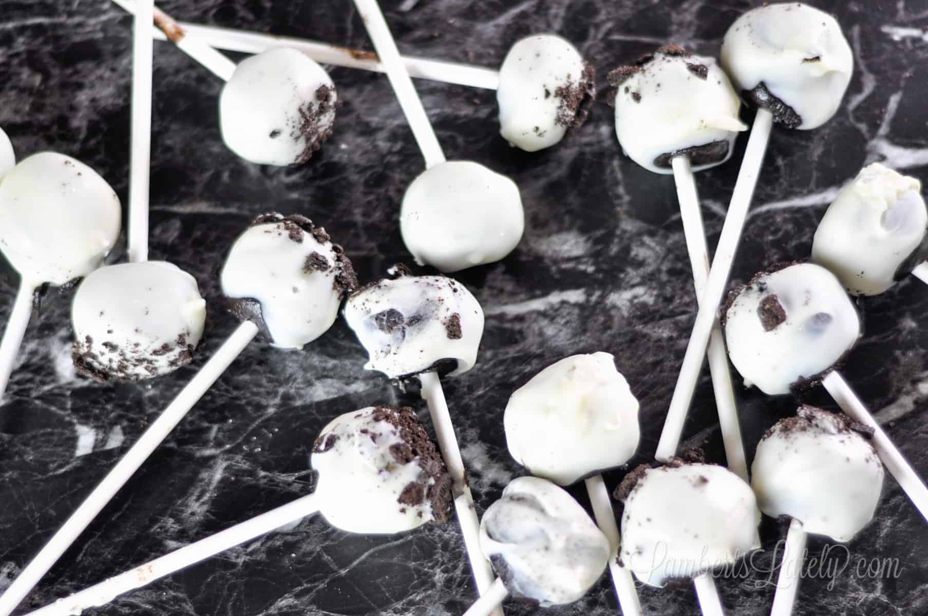 oreo cake pops laying on a counter.