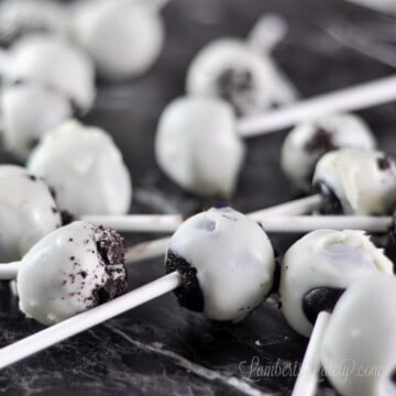 oreo cake pops laying on a counter.