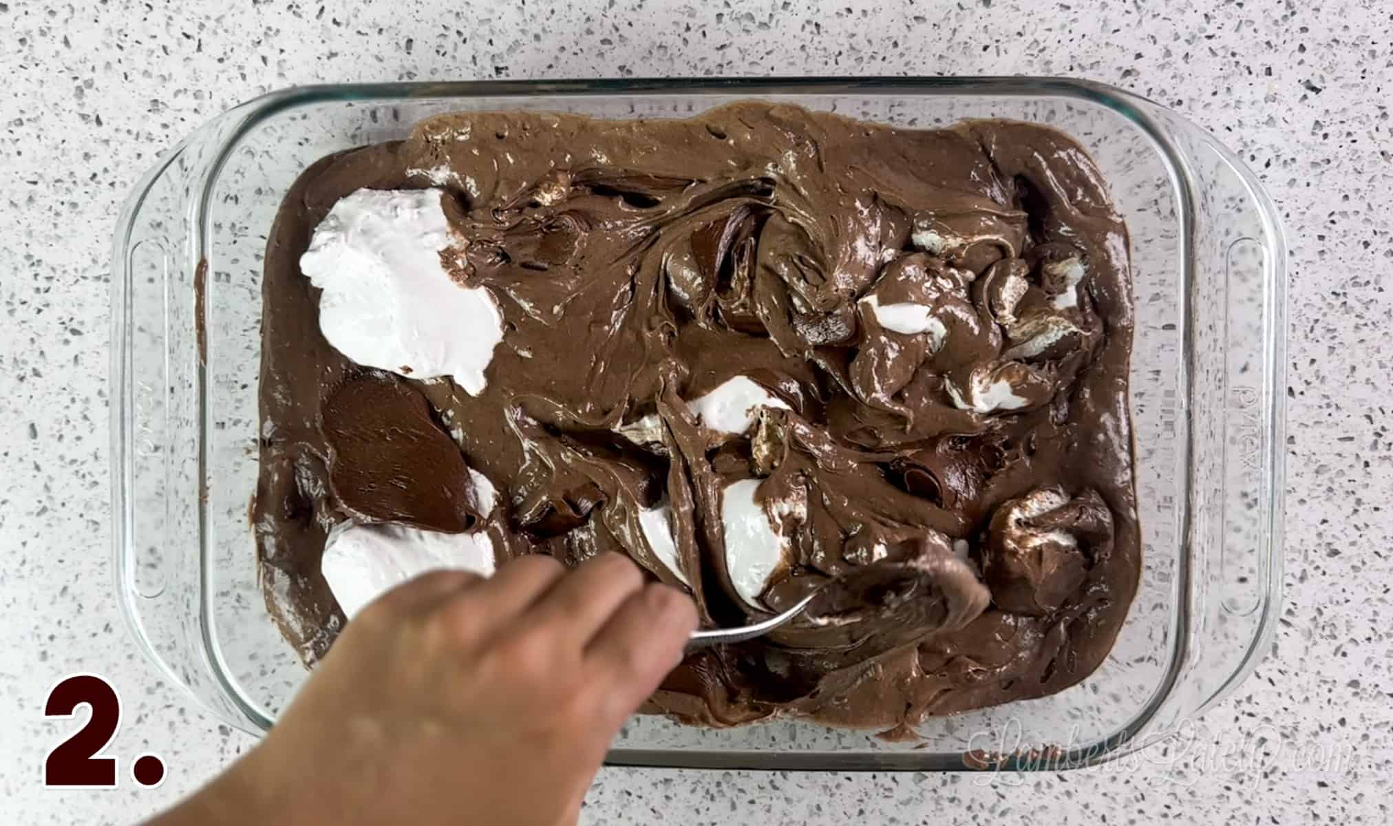 swirling marshmallow fluff and chocolate frosting into a cake batter.