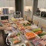Organized air fryer freezer meal prep with various ingredients on a kitchen counter.