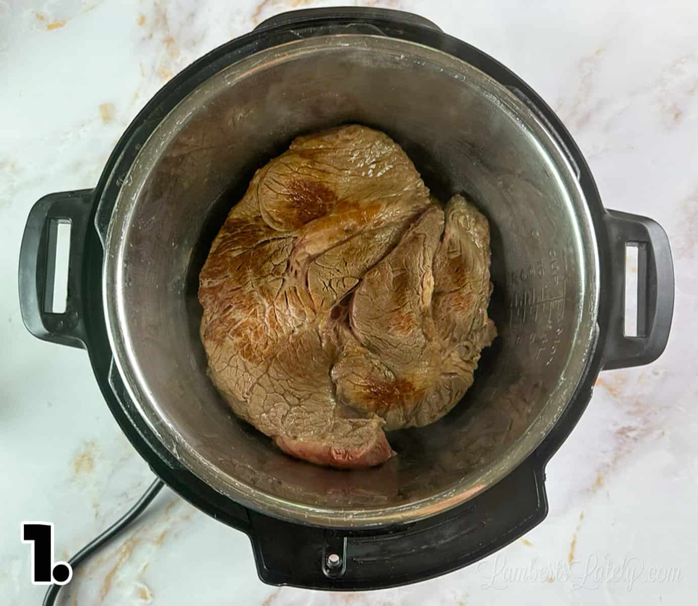 browning a beef chuck roast in an instant pot.