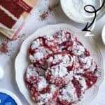 Red Velvet Crinkle Cookies dusted with powdered sugar on a white plate.