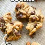 Bakery style peanut butter cookies loaded with chocolate chips on a baking sheet.