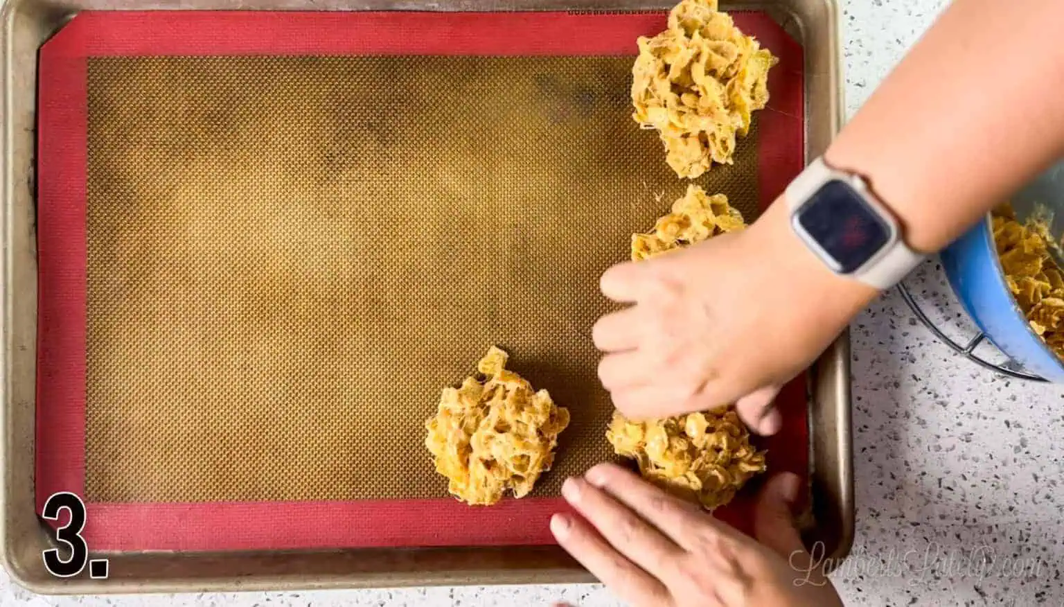 forming fluffernutter cookies with hands on a silicone baking mat.