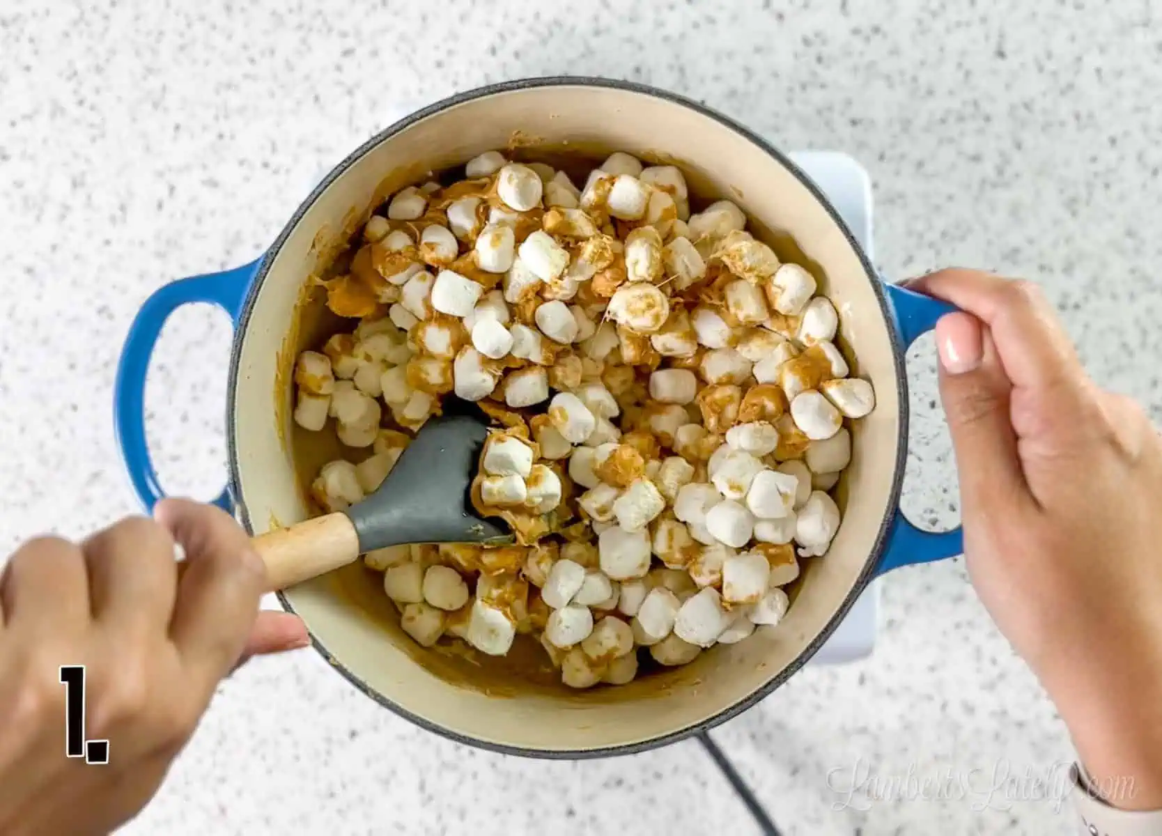 peanut butter and marshmallows being stirred in a pan.