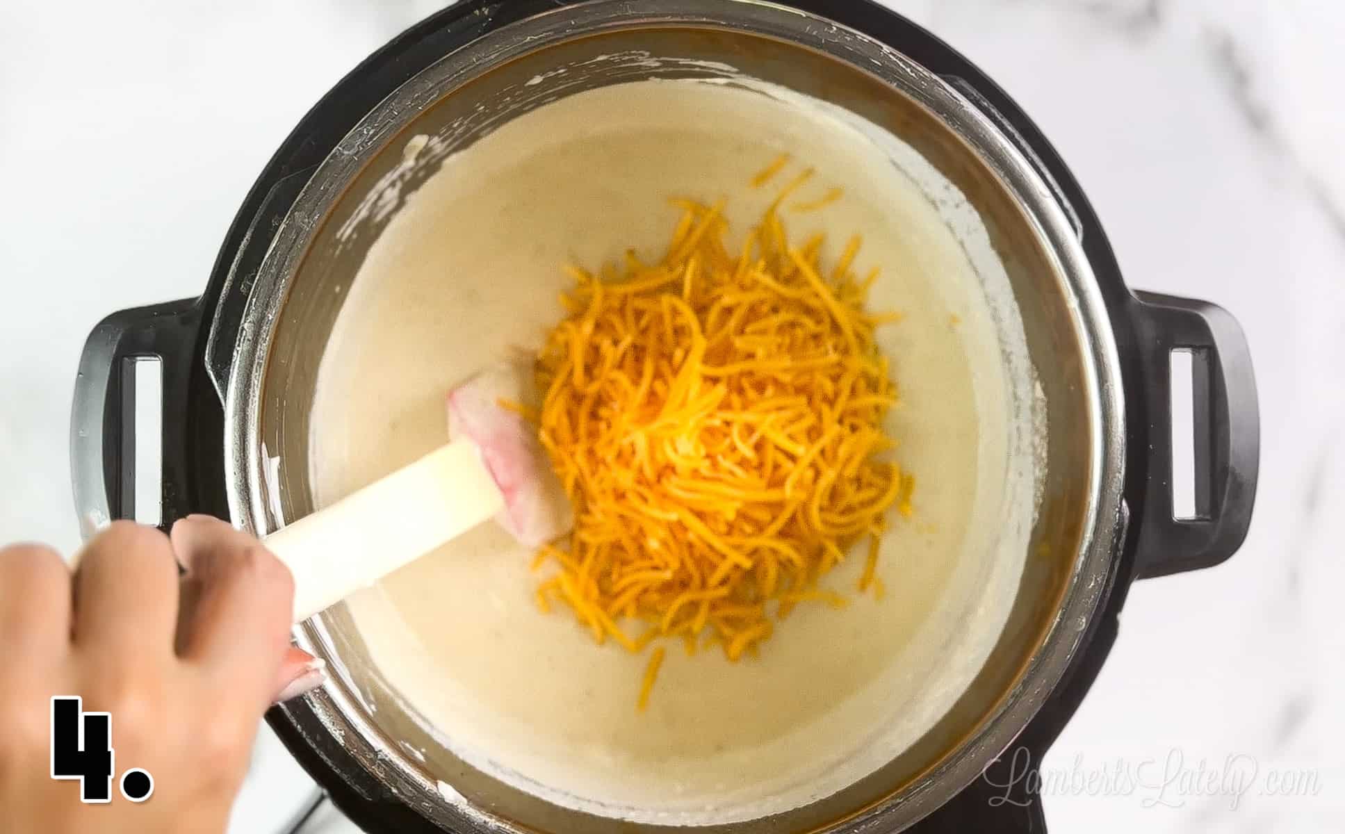 adding cheese into potato soup in the instant pot.