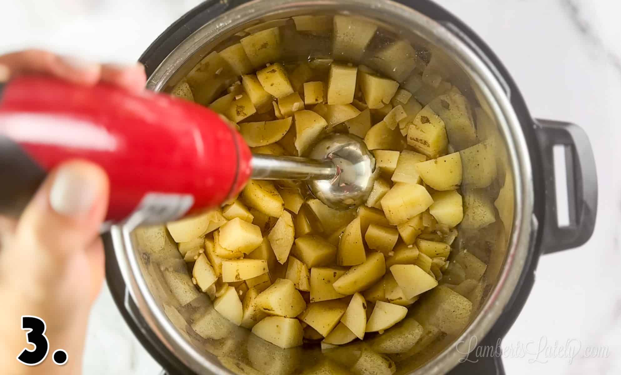 using an immersion blender to puree potatoes in an instant pot.