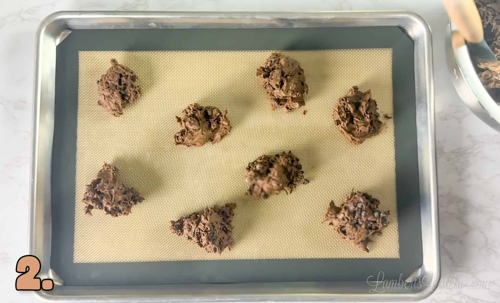 brownie mix cookie dough scooped onto a baking sheet in small portions.