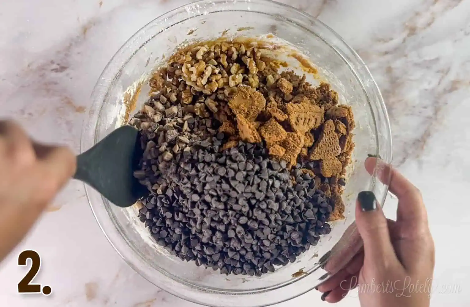 folding in chocolate chips, biscoff cookies, toffee bits, and walnuts.