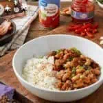 Close-up of a bowl of Hoppin' John with rice and seasoned black-eyed peas.