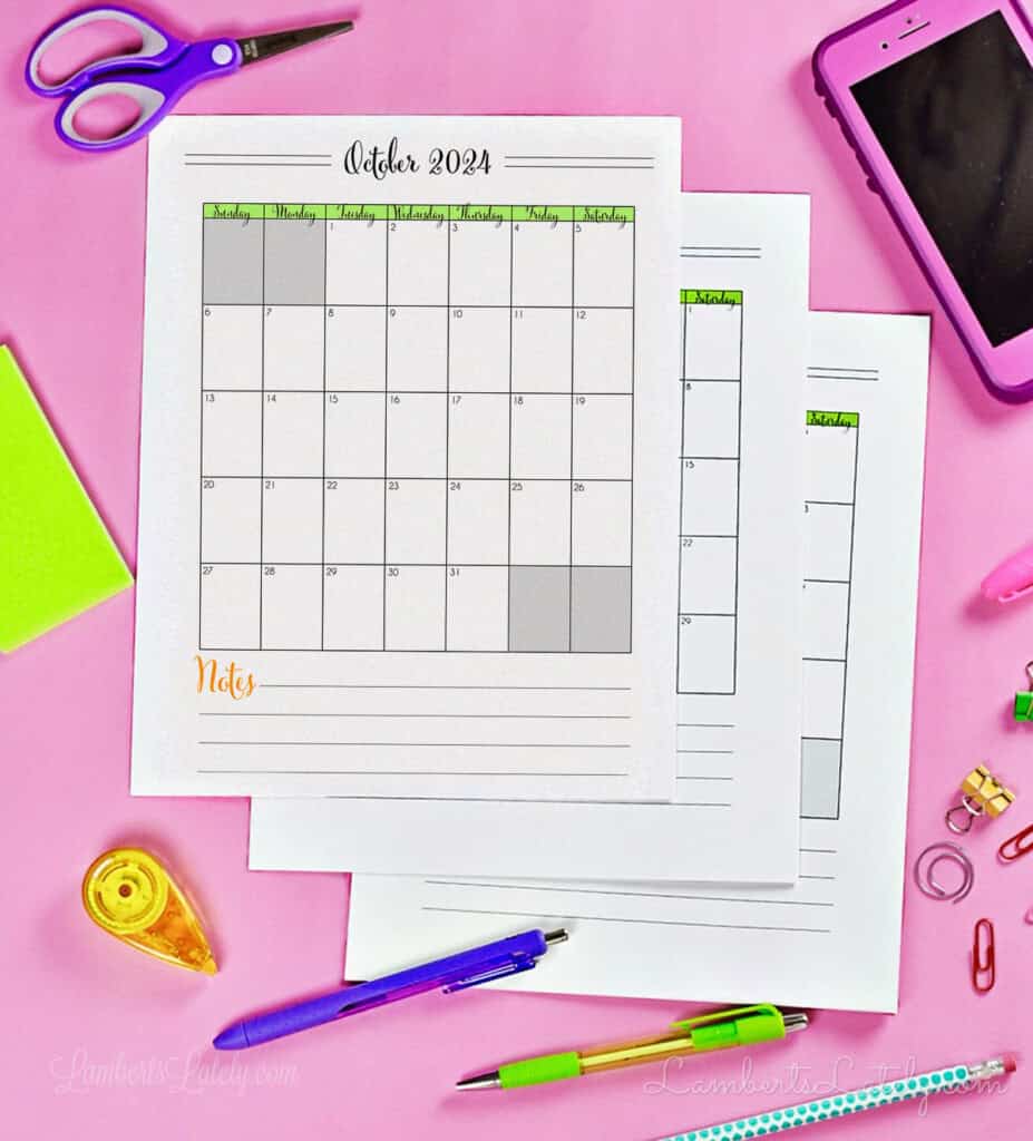 stack of calendar printables on a desk.