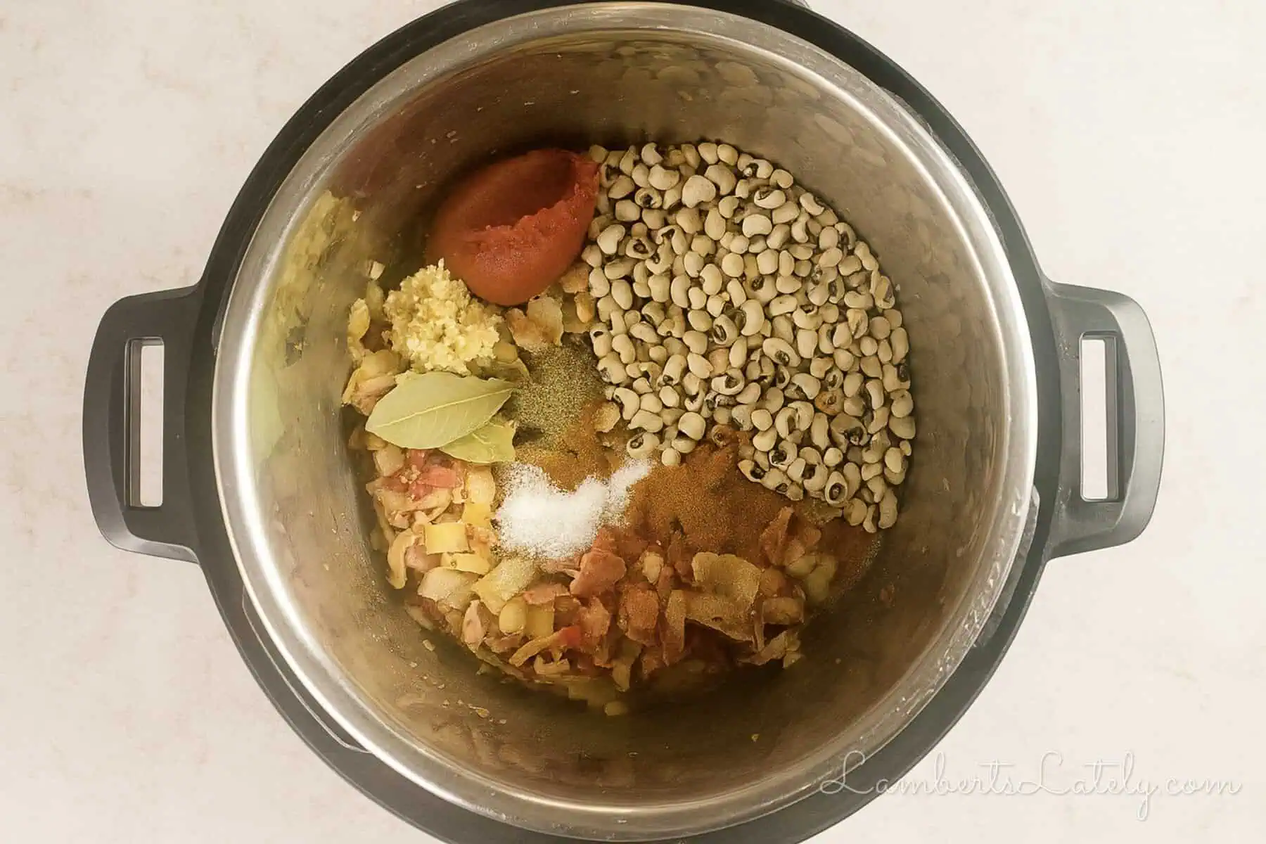 remaining ingredients (black eyed peas, spices, garlic, tomato paste) added to the instant pot.
