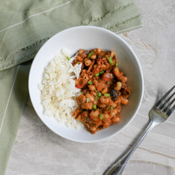 instant pot hoppin john in a bowl, next to a fork, napkin.