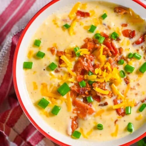 bowl of crockpot corn chowder topped with bacon, cheese, green onions.