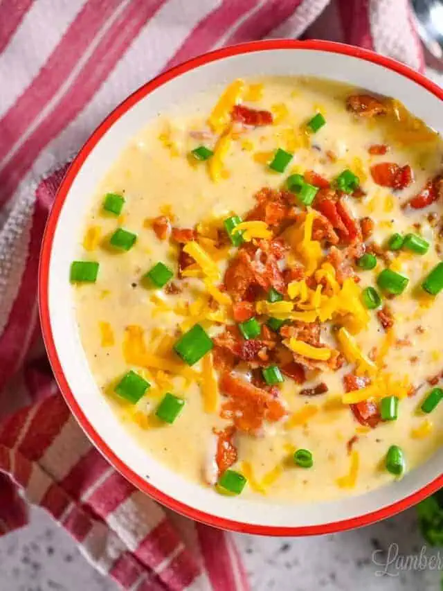bowl of crockpot corn chowder topped with bacon, cheese, green onions.