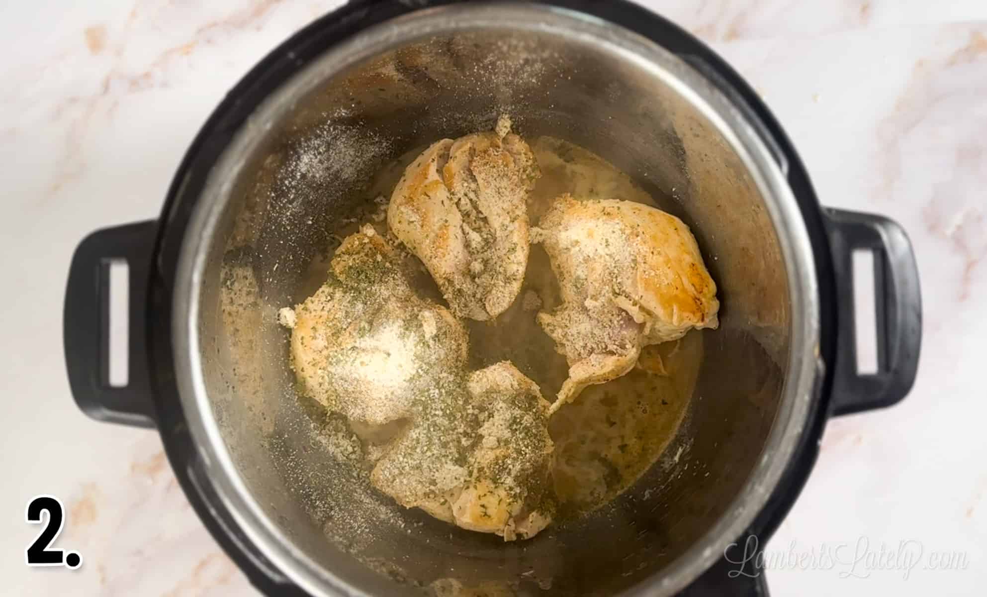 seared chicken topped with spices in an instant pot.