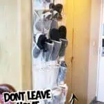 Organized shoe storage with multiple pairs of shoes on a wall-mounted rack in a home entryway.