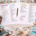 Family cruise packing list with travel essentials and beach accessories on a wooden table.