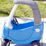 Colorful Little Tikes Cozy Coupe toy car on grass with makeover text.