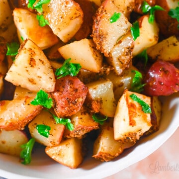 air fryer red potatoes in a bowl, with a garnish of parsley.