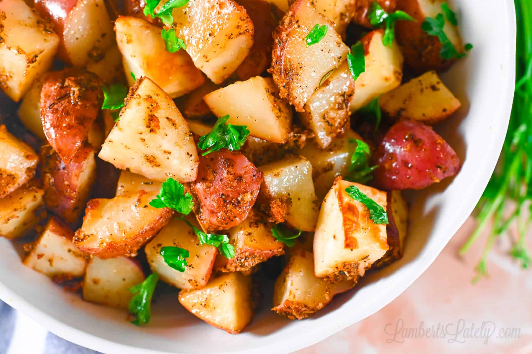 air fryer red potatoes in a bowl, with a garnish of parsley.