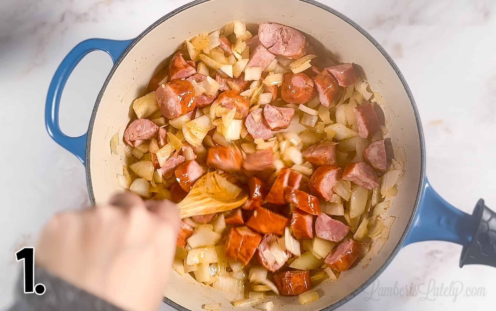 sausage and onions cooking in a pot.