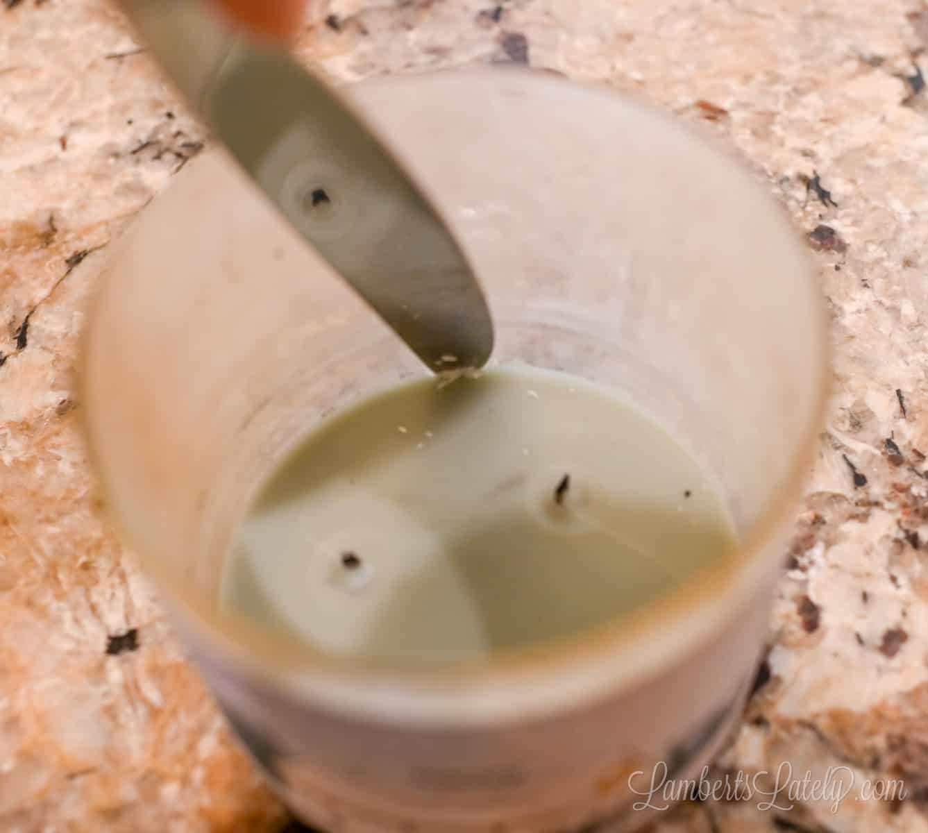 using a butter knife around the edge of the wax in a jar.