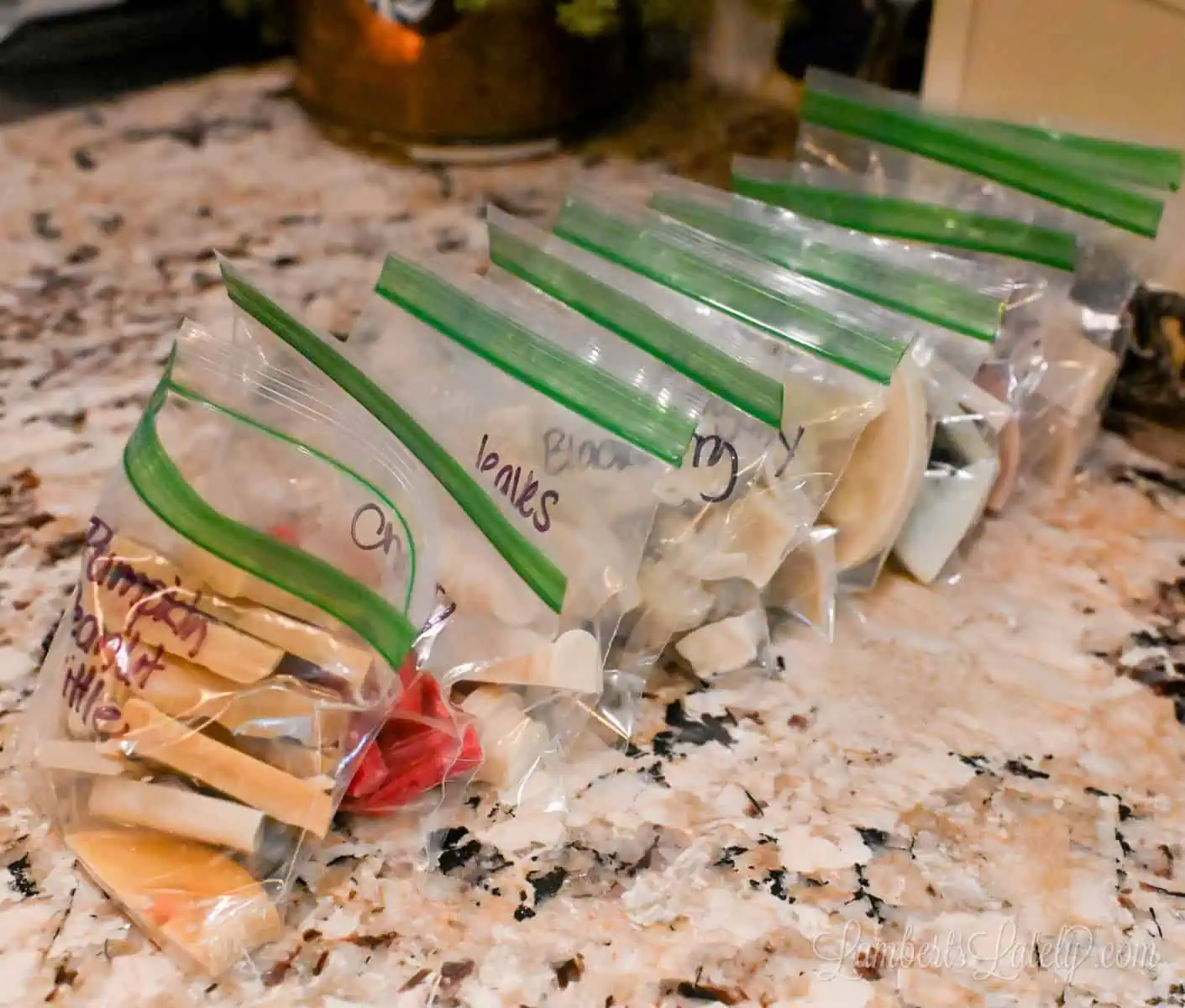 bags of wax melts lined up on a counter.