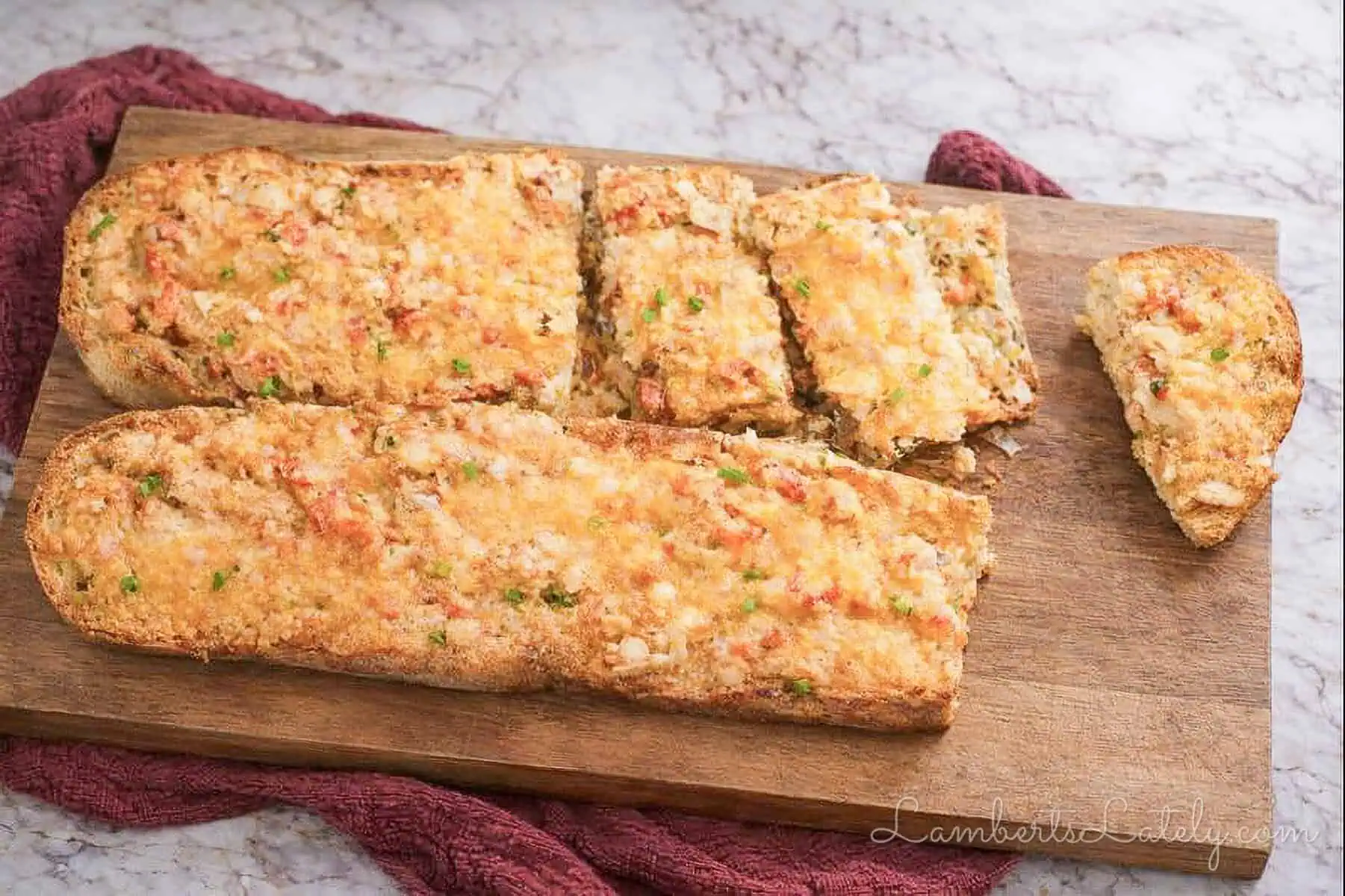loaves of crawfish bread on a cutting board.