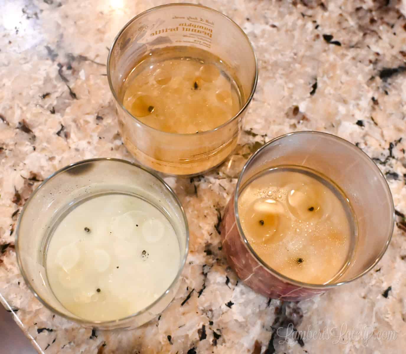 three candle jars with hot water in them.