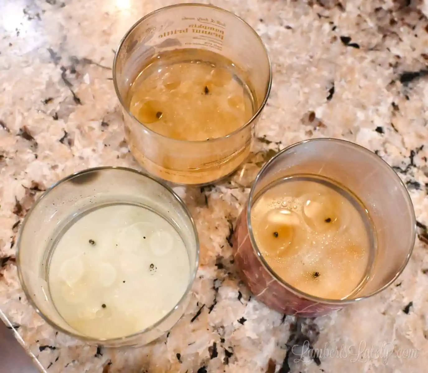 three candle jars with hot water in them.