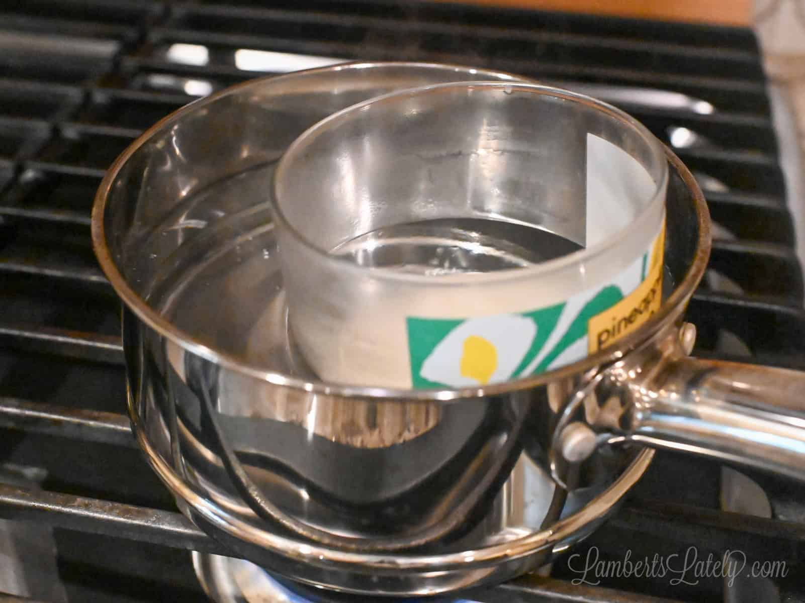 used candle in a saucepan on the stove.