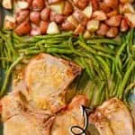 Sheet pan pork chops with potatoes, green beans, and roasted vegetables.