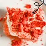 Close-up of strawberry Tres Leches cake with fresh strawberries and whipped cream.