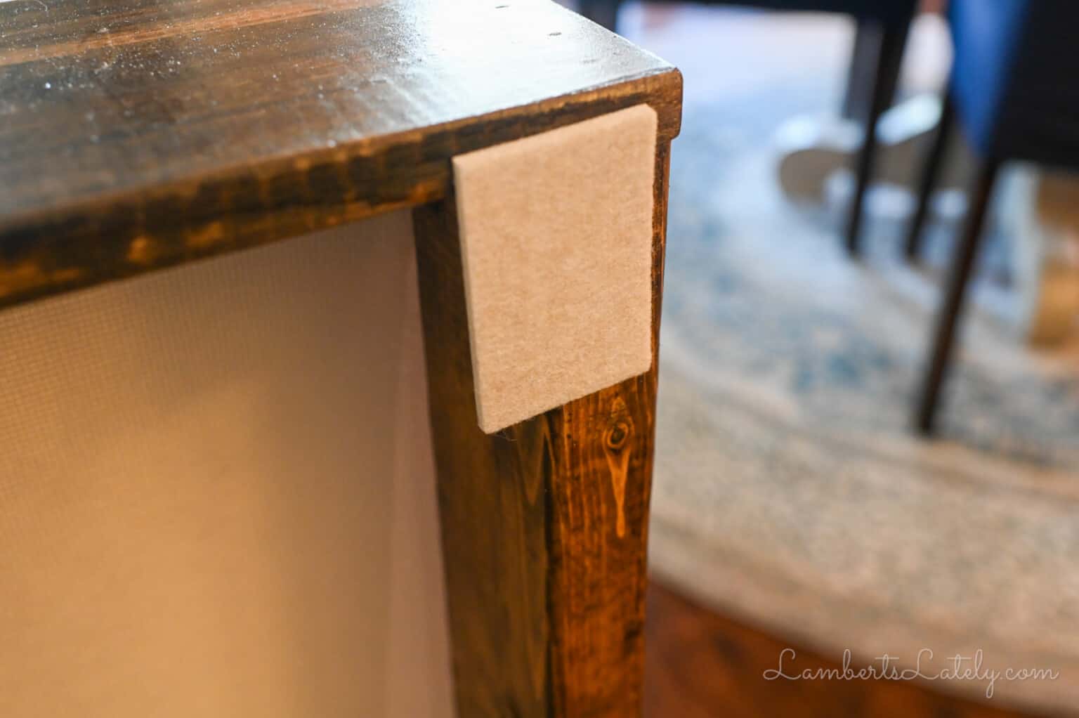 felt pad on the back of a behind the couch table.