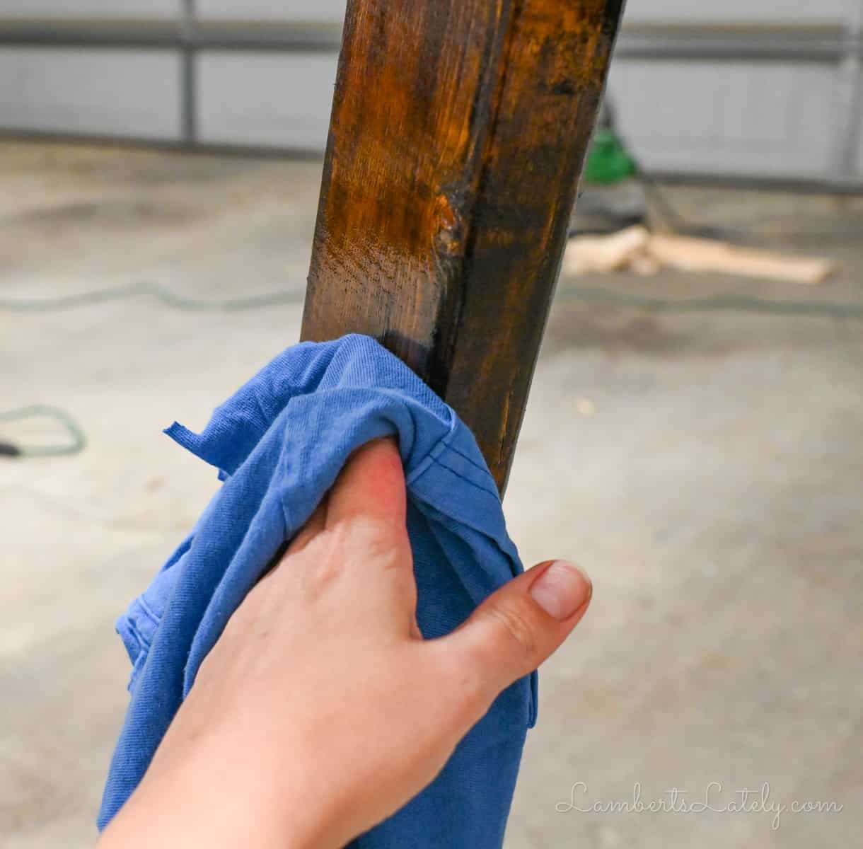 rubbing stain off of wood with an old t-shirt.