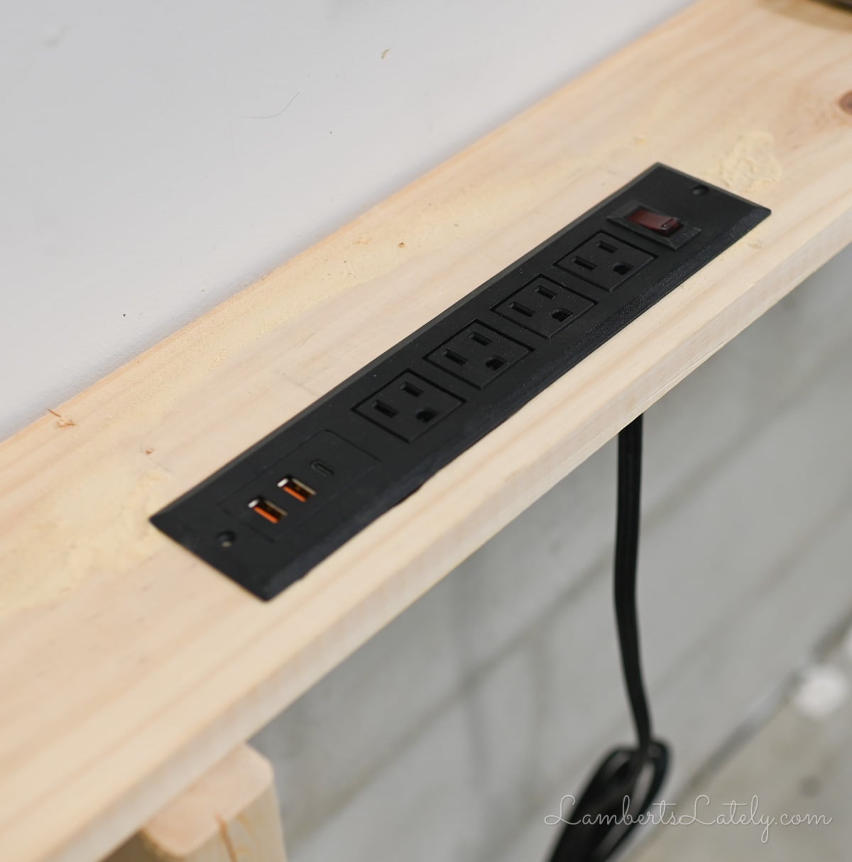 power strip in hole in the table.