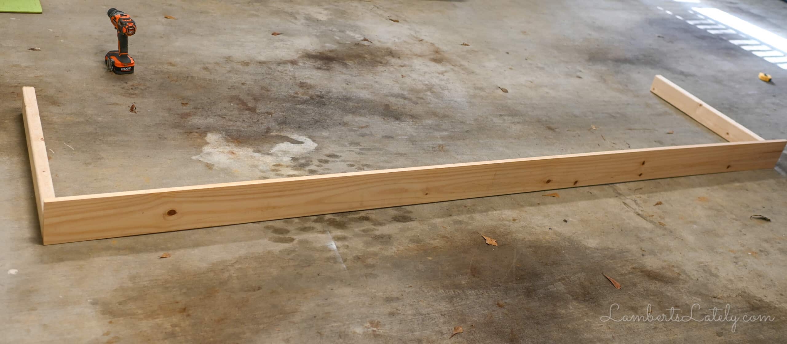 table with two legs on a garage floor.