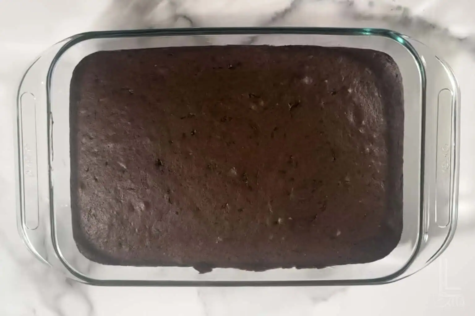 chocolate cake in a 9x13" glass dish.