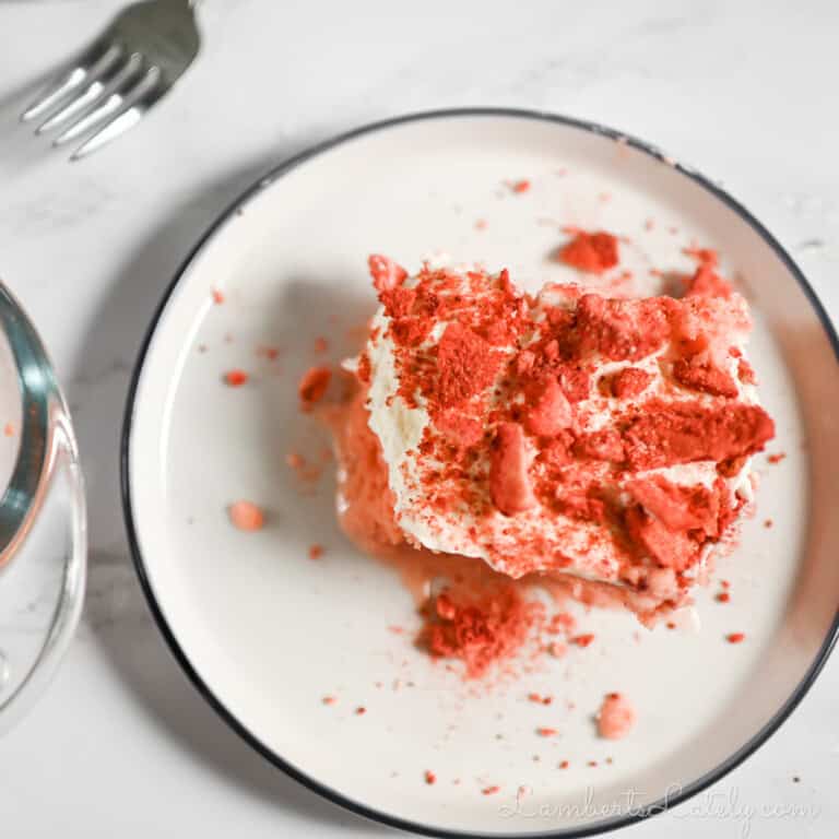 piece of strawberry tres leches cake on a plate.