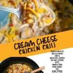 Cream cheese chicken chili in a black pot with a wooden spoon, topped with shredded cheese.