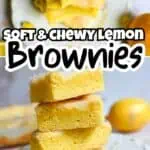 Stack of soft, chewy lemon brownies with a bright yellow lemon in the background.