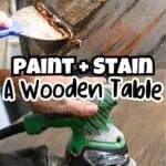 Applying stain to a wooden table with a power sander nearby for refinishing.