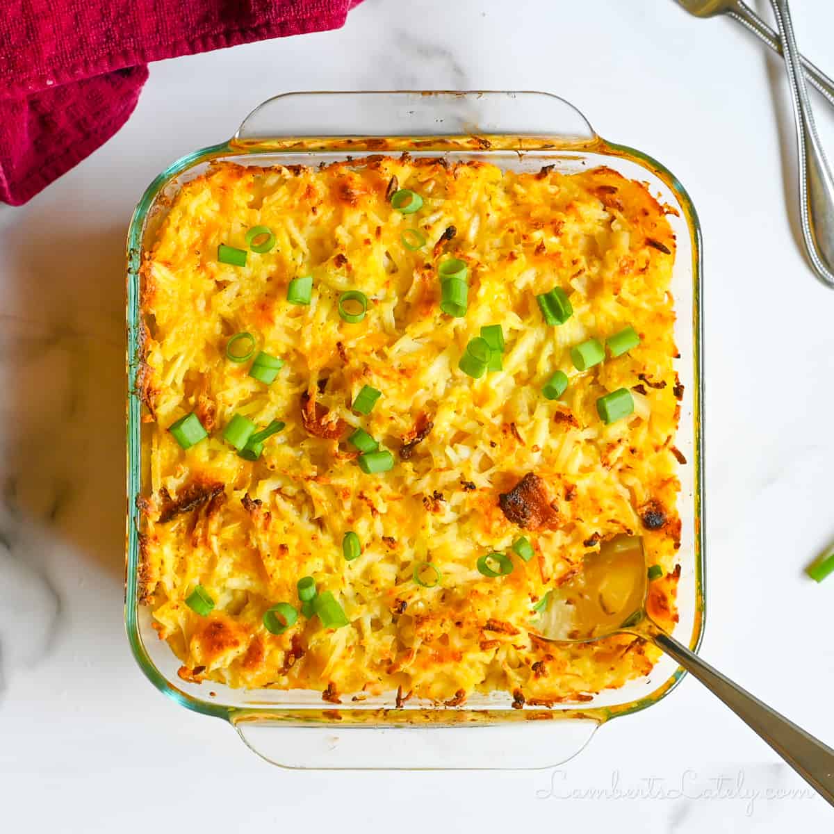 crack potatoes, with a cheesy, crispy, top, in a glass casserole dish.