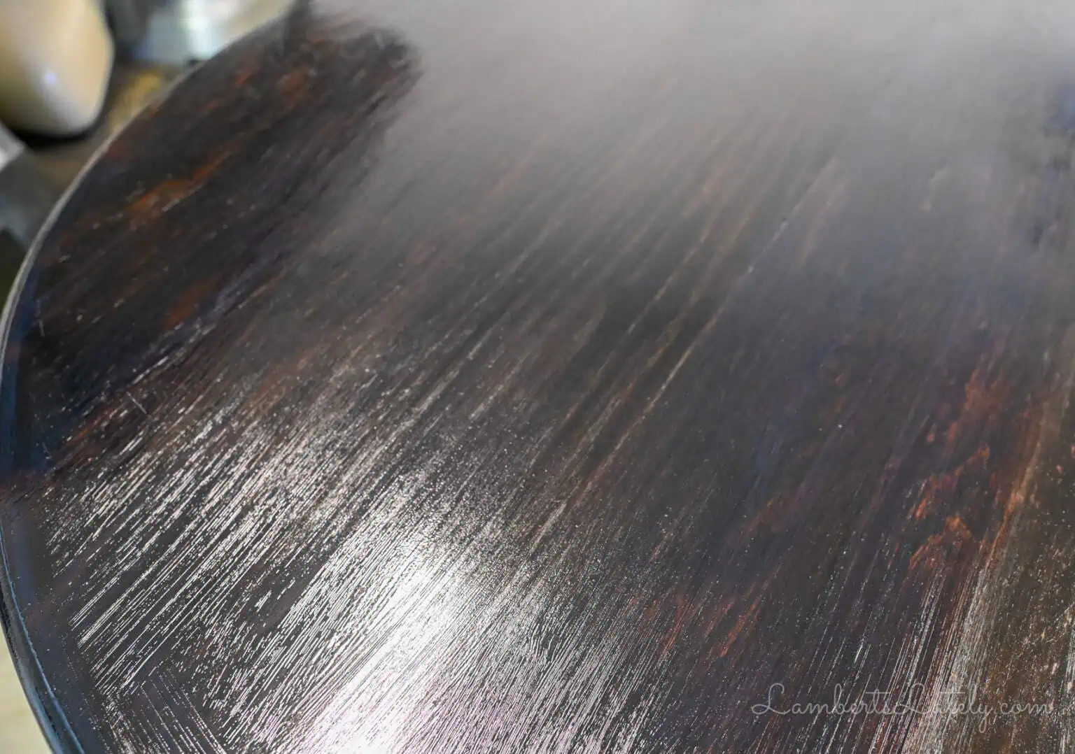 coat of wet polyurethane on a dark stained wood table.