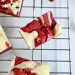 Red velvet cake mix brownies on a cooling rack with festive decorations.