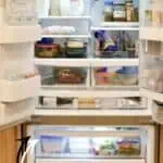 Organized refrigerator with labeled bins and neatly arranged food items for easy access.